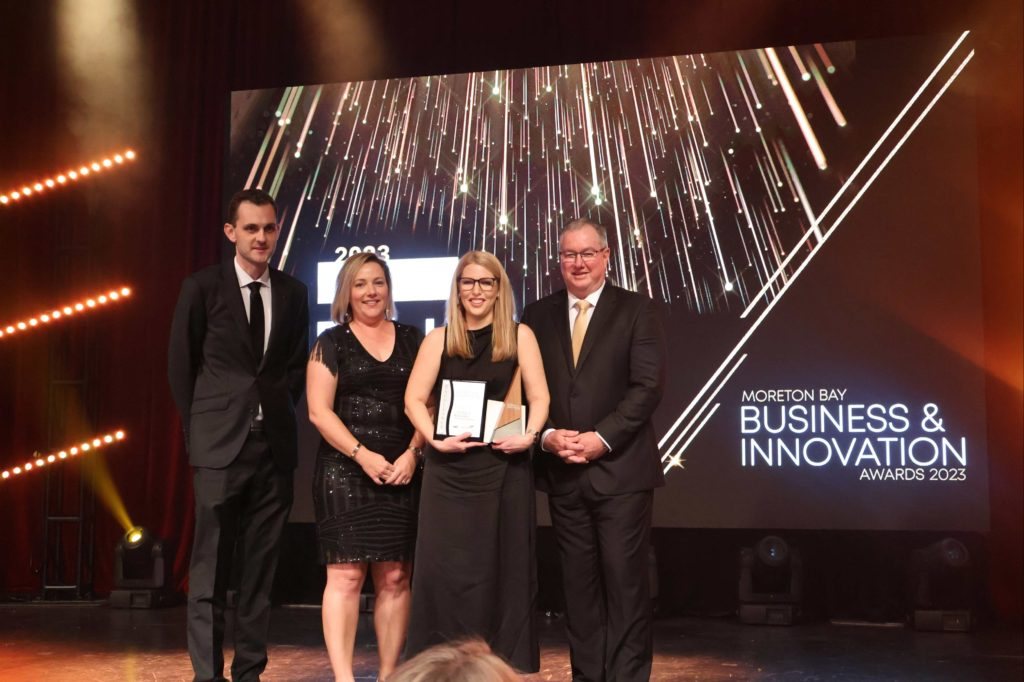 Ruth Limkin on stage receiving an award at the Moreton Bay Business and Innovation Awards