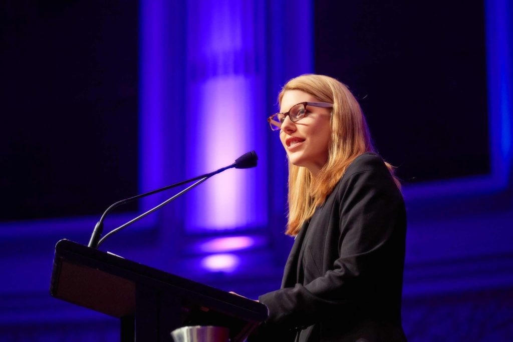 Ruth Limkin delivering a keynote at a lectern